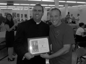 Fr. Robert Sinatra receives the Chaplain of the Year Award from Assumption Council #3397 Grand Knight Ray Iacovone.