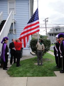 Grand Knight Ray Iacovone assists in the raising of the flag.  