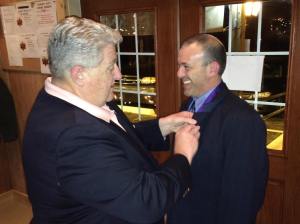 Grand Knight Ray Iacovone receives his Star Award pin from District Deputy Mike Walter.  